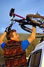 a typical mountain biker carries his mountain bike on his SUV